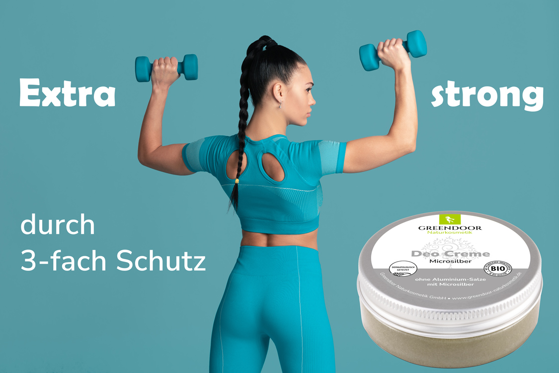 Greendoor Deo Creme Microsilber mit junger Frau, die Gewichte stemmt und der Aussage Extra strong durch dreifach Schutz